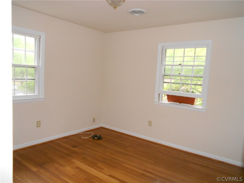11019 Rockledge Road Richmond, VA 23235 - Photo 30 of 36 an empty room with wooden floor and windows