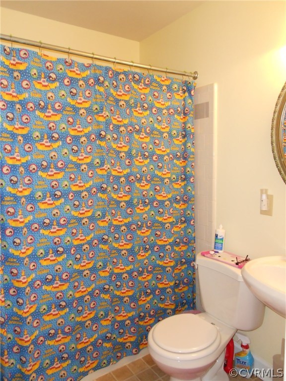 11019 Rockledge Road Richmond, VA 23235 - Photo 32 of 36 a white toilet sitting next to a shower curtain