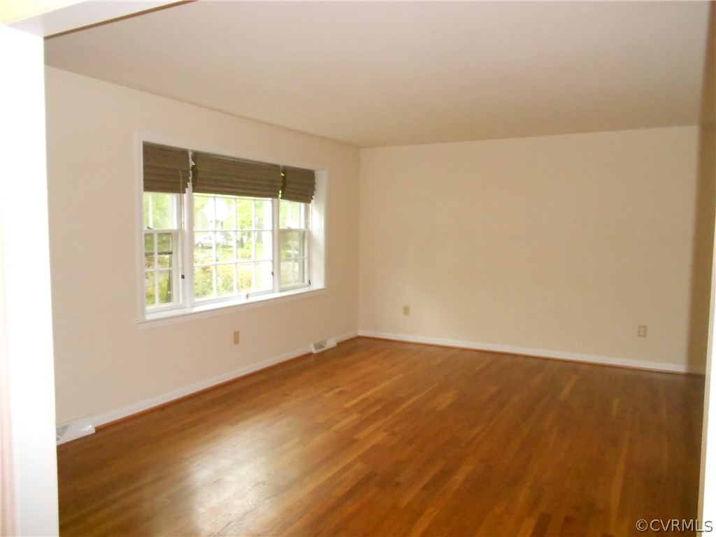 11019 Rockledge Road Richmond, VA 23235 - Photo 6 of 36 an empty room with wooden floor and windows