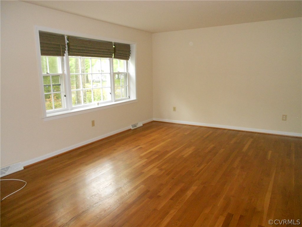 11019 Rockledge Road Richmond, VA 23235 - Photo 7 of 36 an empty room with wooden floor and windows