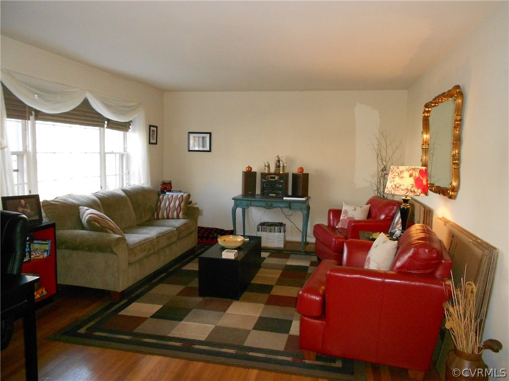 11019 Rockledge Road Richmond, VA 23235 - Photo 8 of 36 a living room with furniture a flat screen tv and a window