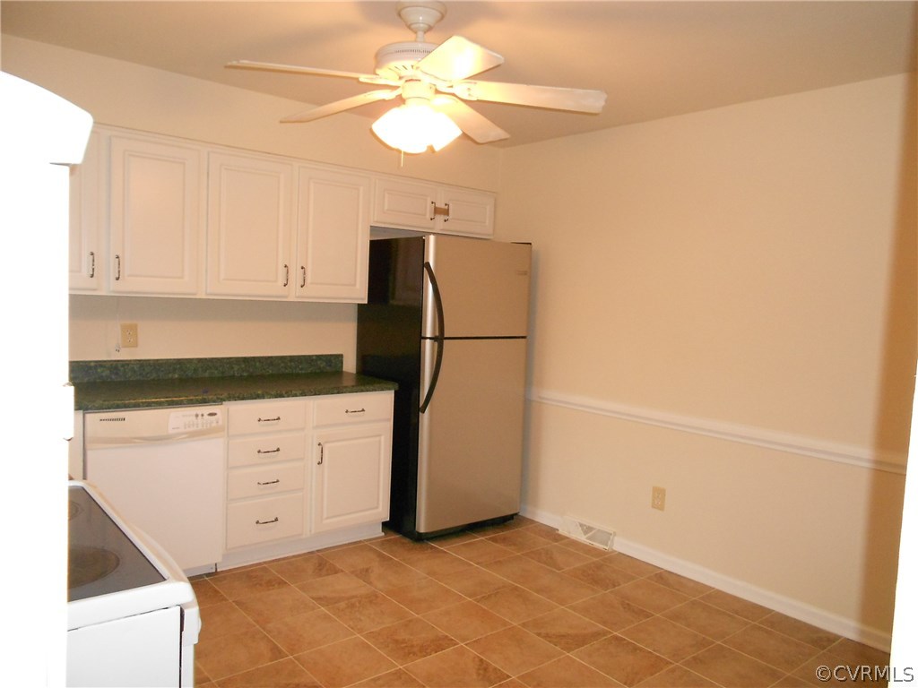 11019 Rockledge Road Richmond, VA 23235 - Photo 9 of 36 a kitchen with a refrigerator and cabinets