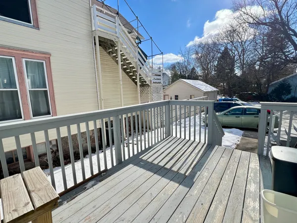 a view of a wooden deck with furniture