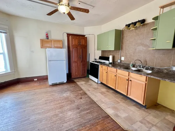 a kitchen with stainless steel appliances granite countertop a stove a sink and a refrigerator