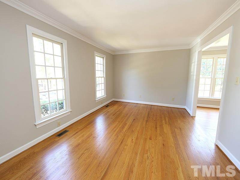 7621 Pinewild Court Raleigh, NC 27615 - Photo 2 of 14 an empty room with wooden floor and windows