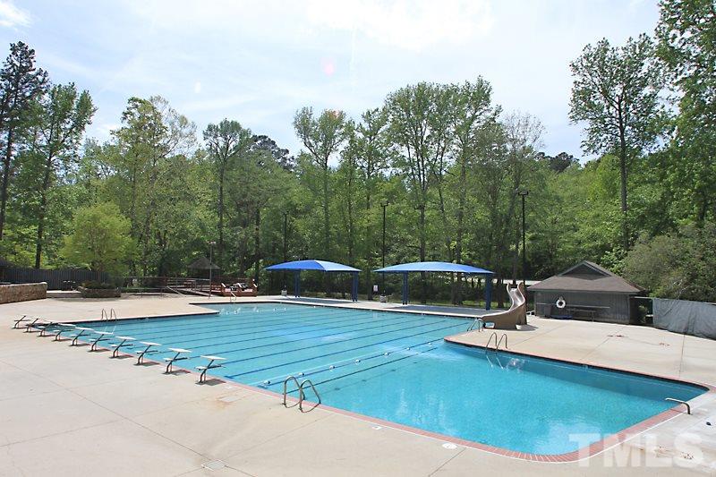 7621 Pinewild Court Raleigh, NC 27615 - Photo 13 of 14 a view of a swimming pool with a yard