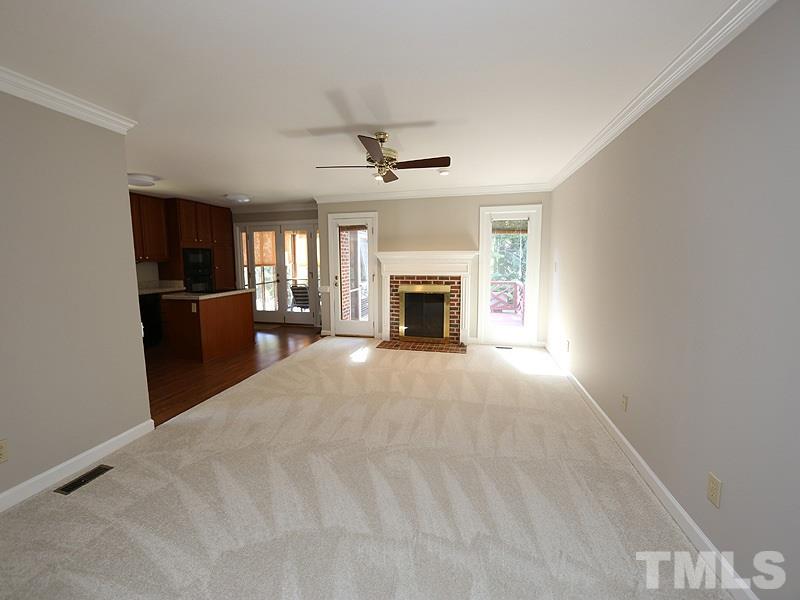 7621 Pinewild Court Raleigh, NC 27615 - Photo 4 of 14 wooden floor fireplace and windows in an empty room