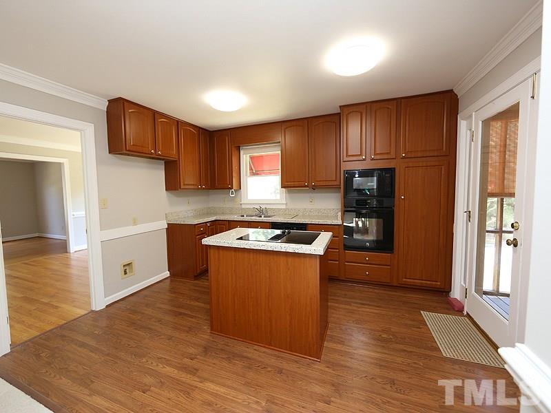 7621 Pinewild Court Raleigh, NC 27615 - Photo 5 of 14 a kitchen with stainless steel appliances granite countertop a stove a sink dishwasher and a refrigerator