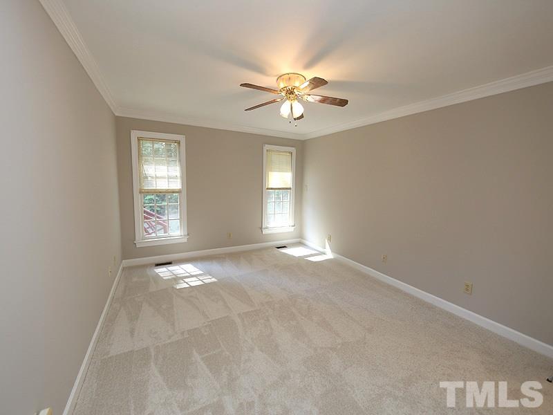 7621 Pinewild Court Raleigh, NC 27615 - Photo 7 of 14 an empty room with windows and fan