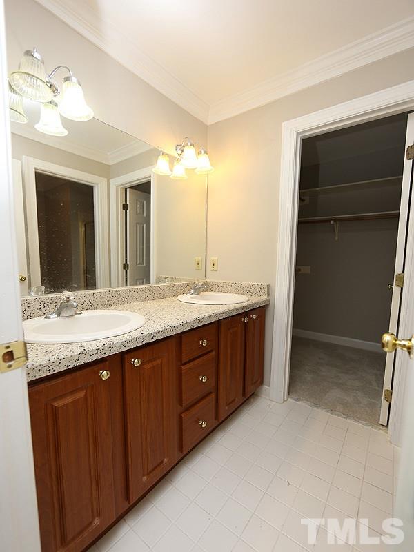 7621 Pinewild Court Raleigh, NC 27615 - Photo 8 of 14 a bathroom with a granite countertop sink and a mirror