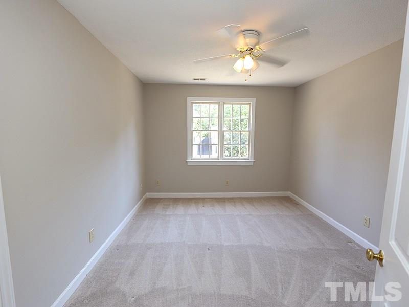 7621 Pinewild Court Raleigh, NC 27615 - Photo 9 of 14 wooden floor in an empty room with a window