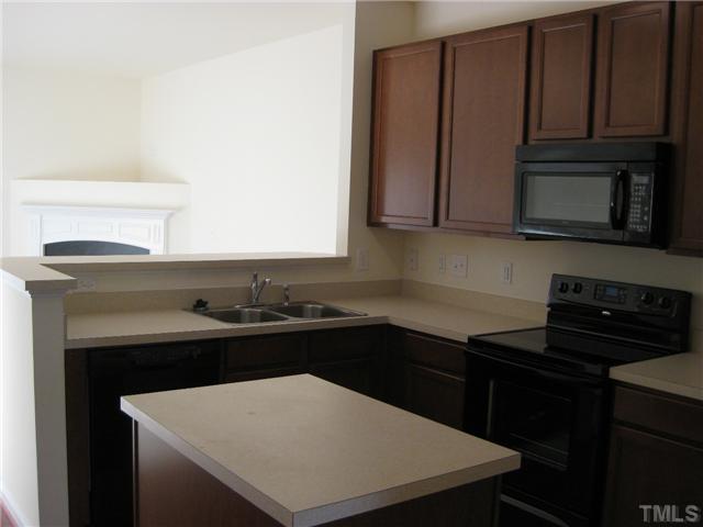 1648 Holly Grove Way Durham, NC 27713 - Photo 3 of 7 Plenty of counter space & a working island with cabinets underneath make this kitchen very user friendly! Smooth-top range, built-in microwave and dishwasher included!