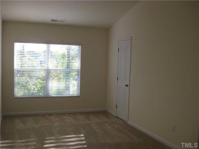 1648 Holly Grove Way Durham, NC 27713 - Photo 5 of 7 Master bedroom with vaulted ceiling with walk in closet (door pictured here) and bathroom with double sinks & garden tub (door not pictured here but is to the right)