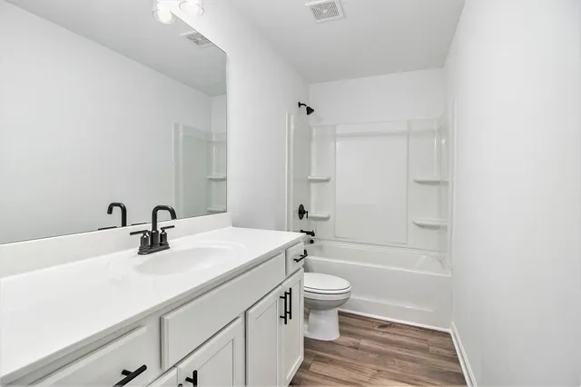 a bathroom with a sink toilet tub and shower