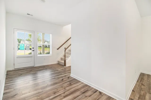 a view of an entryway with wooden floor