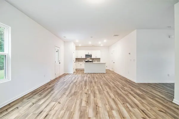 a view of a kitchen with wooden floor
