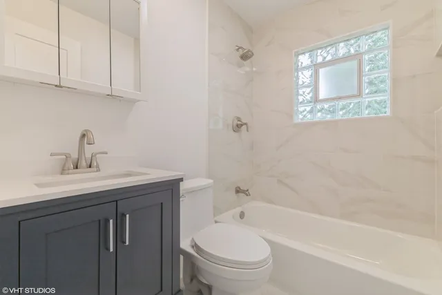 a bathroom with a sink a toilet and bathtub