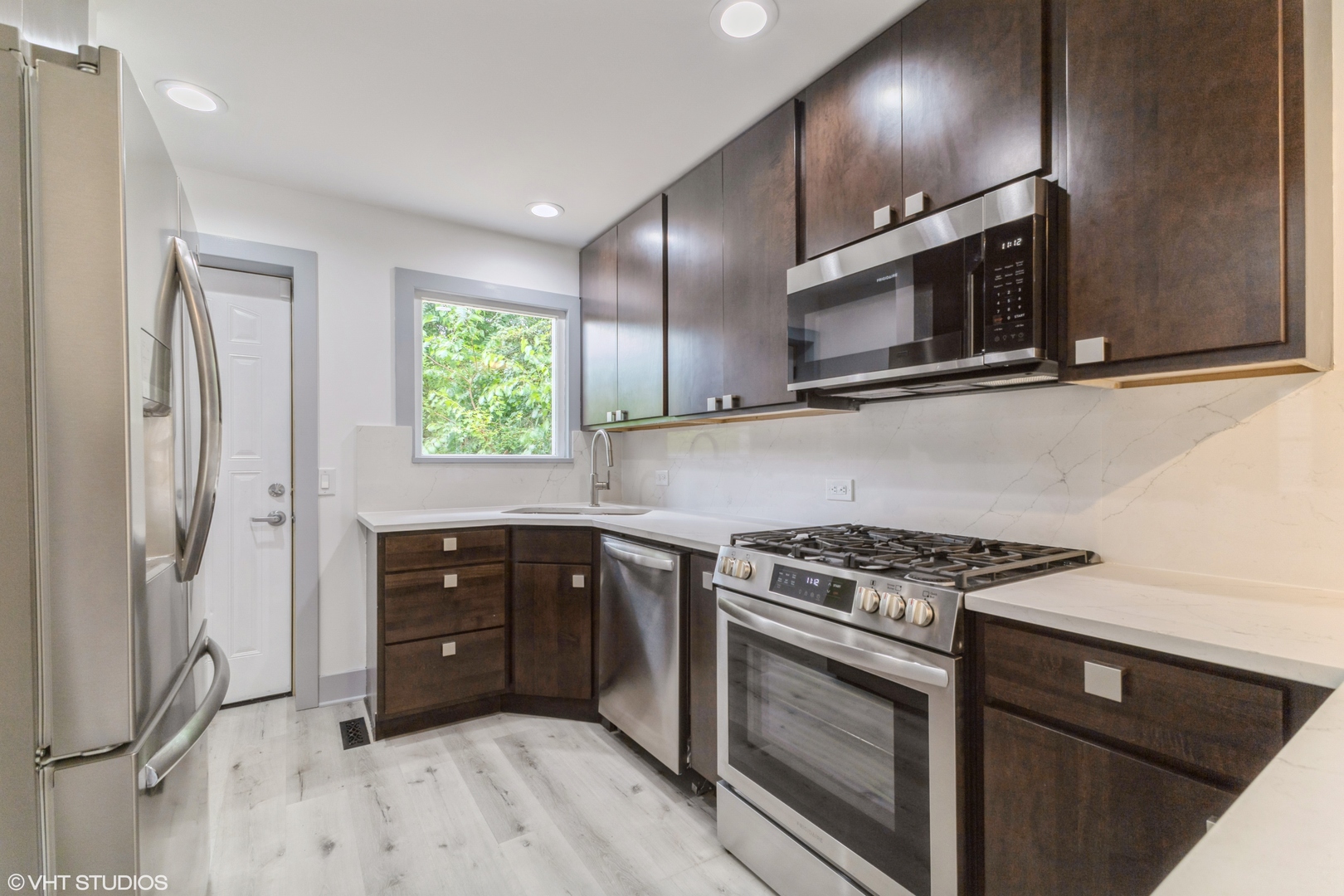 14727 East Riverside Drive South Holland, IL 60473 - Photo 7 of 12 a kitchen with stainless steel appliances granite countertop a stove a microwave and a refrigerator