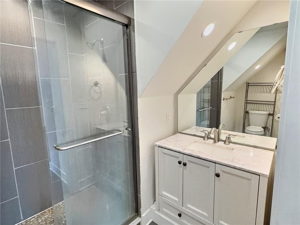 611 Blackburn Road, Unit 3 Sewickley, PA 15143 - Photo 10 of 16 a bathroom with a shower sink and mirror