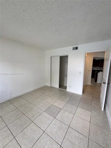 a view of an empty room and a window