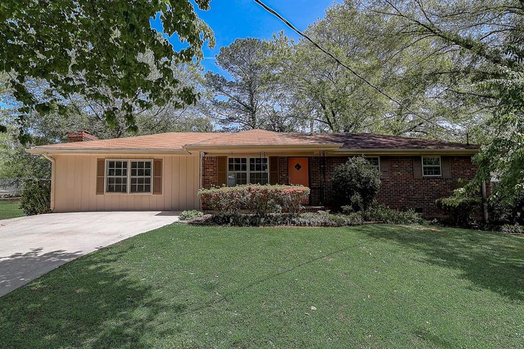 2969 Old Lost Mountain Road Powder Springs, GA 30127 - Photo 1 of 1 a front view of a house with a garden