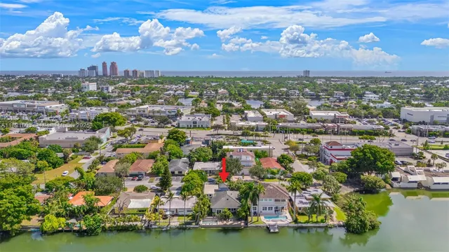 an aerial view of residential houses with outdoor space and lake view