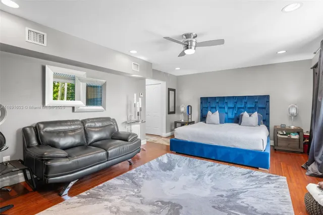 a bedroom with a bed couch and window