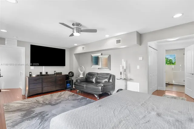 a bedroom with furniture and a flat screen tv