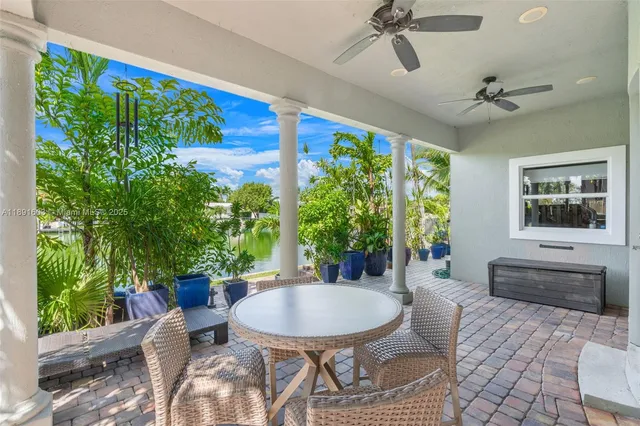 a outdoor living space with furniture potted plant and a window