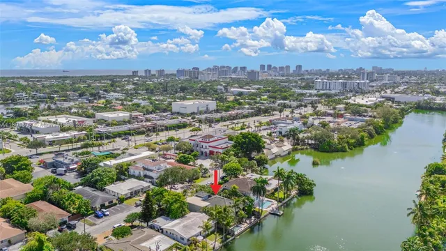 an aerial view of residential houses with outdoor space and trees
