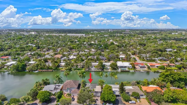 an aerial view of residential houses with outdoor space and lake view