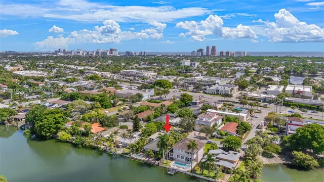 an aerial view of residential houses with outdoor space and lake view