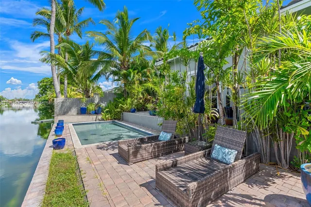 a view of a backyard with couches chair and grass