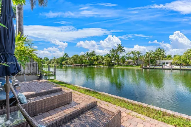 a view of a lake with couches in the patio