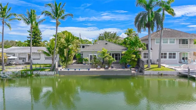 a view of an house with swimming pool and chairs