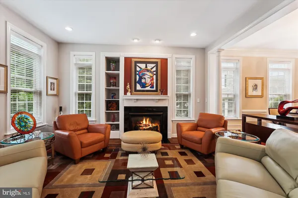 a living room with furniture fireplace and window