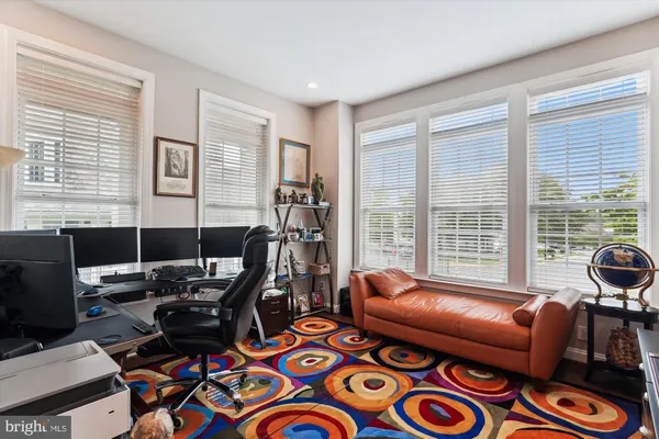 a living room with furniture kitchen view and a chandelier