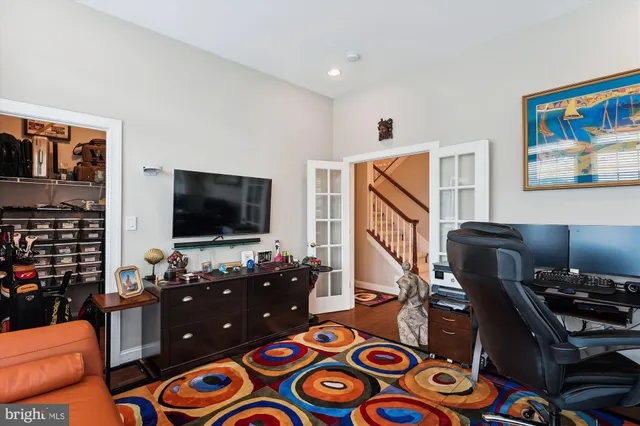 a living room with granite countertop furniture and wooden floor
