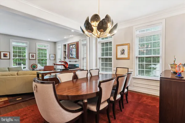 a dining room with furniture and a kitchen view