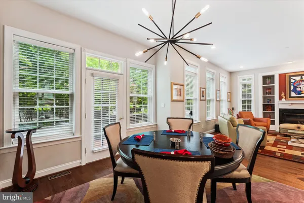 a spacious bedroom with a large bed a chandelier and a window