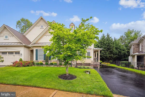 a view of a house with a yard and a garden