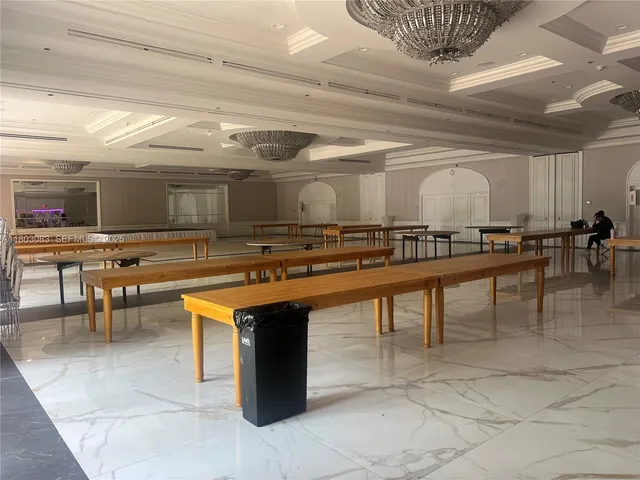 a view of a room with shelves and wooden floor