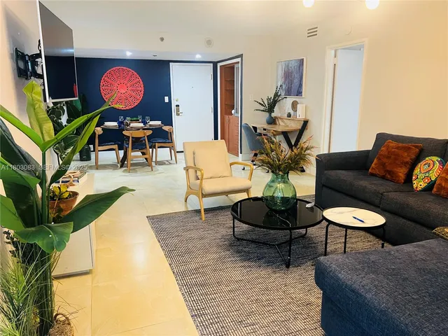 a living room with furniture a rug and a mirror