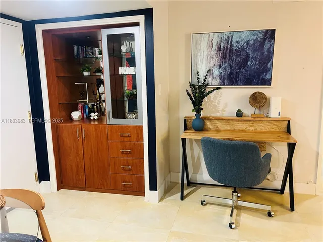 a view of a bedroom with a bed and furniture