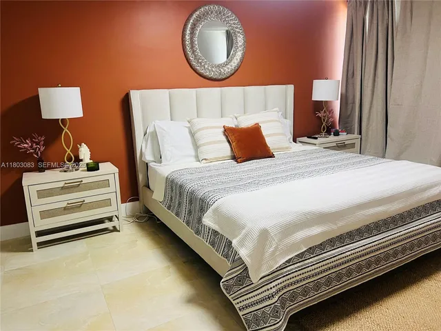 a bedroom with a bed and a flat screen tv