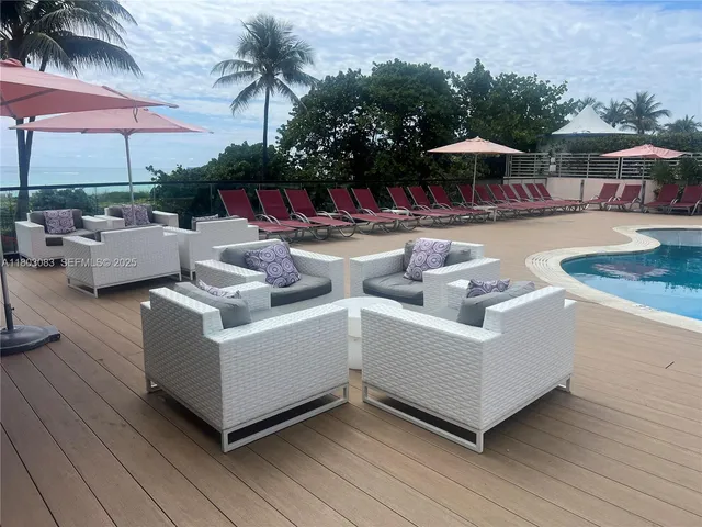 a view of a patio with couches and chairs with wooden floor