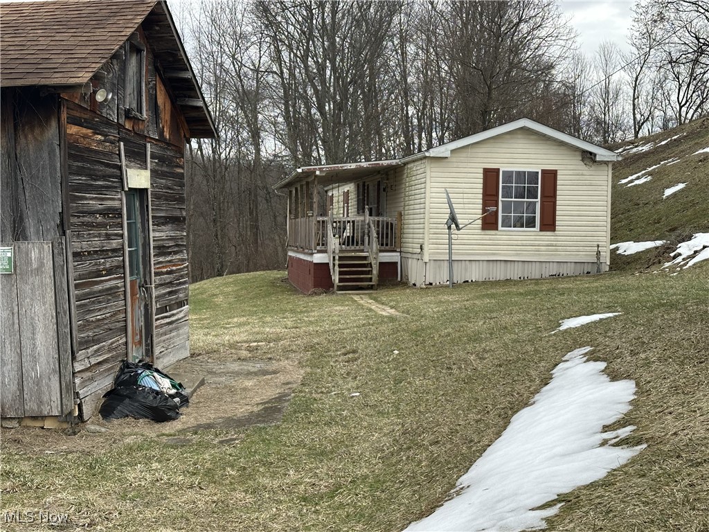 3356 Postlethwait Ridge Littleton, WV 26581 - Photo 15 of 18 View of side of home featuring a yard