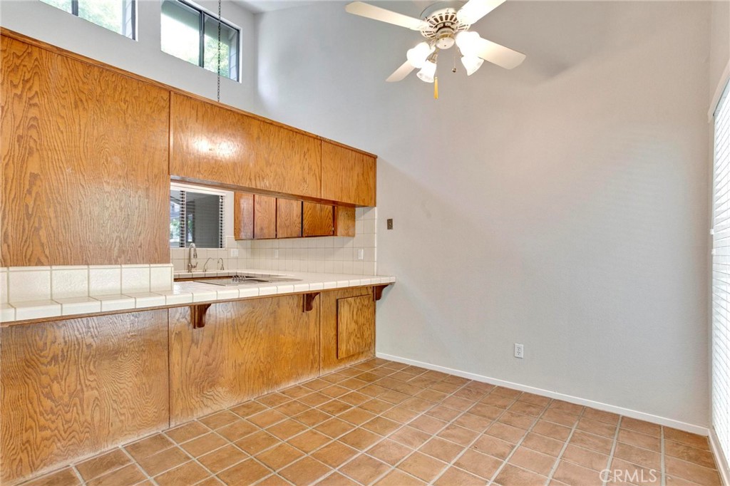 3350 M Street, Unit 24 Merced, CA 95348 - Photo 11 of 38 a view of a kitchen with kitchen island granite countertop cabinets and window