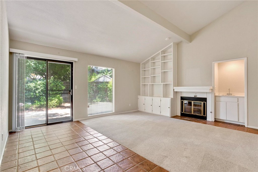 3350 M Street, Unit 24 Merced, CA 95348 - Photo 15 of 38 a view of an empty room with a fireplace and a window