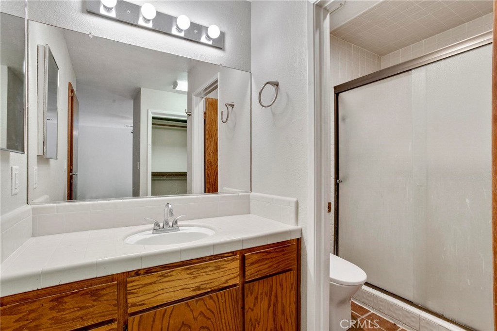 3350 M Street, Unit 24 Merced, CA 95348 - Photo 27 of 38 a bathroom with a granite countertop sink toilet and shower